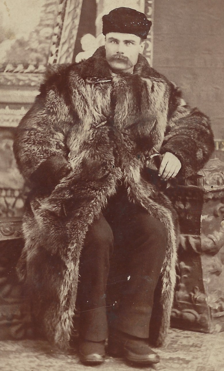Charles H. Sommers, wearing fur coat and hat